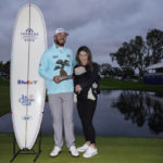 
              Max Homa holds the trophy as he stands alongside his wife, Lacey, and baby Cameron, after winning the Farmers Insurance Open golf tournament, Saturday, Jan. 28, 2023, in San Diego. (AP Photo/Gregory Bull)
            