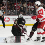 Arizona Coyotes goaltender Connor Ingram (39) gives up a goal to Detroit Red Wings' Dylan Larkin as Red Wings left wing Tyler Bertuzzi (59) looks on during the second period of an NHL hockey game in Tempe, Ariz., Tuesday, Jan. 17, 2023. (AP Photo/Ross D. Franklin)