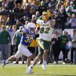 
              CORRECTS TO NORTH DAKOTA STATE NOT NORTH DAKOTA - North Dakota State tight end Joe Stoffel (82) catches a touchdown pass in front of South Dakota State linebacker Payton Shafer (30) during the first half of the FCS Championship NCAA college football game Sunday, Jan. 8, 2023, in Frisco, Texas. (AP Photo/LM Otero)
            