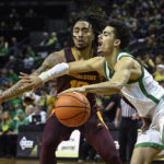 Oregon guard Will Richardson, right, is fouled by Arizona State guard Frankie Collins, left, during the second half of an NCAA college basketball game Thursday, Jan. 12, 2023, in Eugene, Ore. (AP Photo/Andy Nelson)