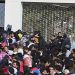 
              Iraqi soccer fans try to enter the Basra International Stadium in Basra, Iraq, Thursday, Jan 19, 2023. A stampede outside the stadium has killed and injured a number of people. (AP Photo/Anmar Khalil)
            
