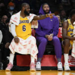 Los Angeles Lakers forward LeBron James (6) sits with Anthony Davis on the bench during the first half of an NBA basketball game against the Sacramento Kings in Los Angeles, Wednesday, Jan. 18, 2023. (AP Photo/Ashley Landis)