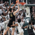Purdue center Zach Edey (15) makes a basket with two seconds on the clock during the second half of an NCAA college basketball game against Michigan State, Monday, Jan. 16, 2023, in East Lansing, Mich. (AP Photo/Carlos Osorio)