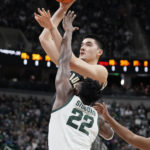 
              Purdue center Zach Edey shoots over the defense of Michigan State center Mady Sissoko (22) during the first half of an NCAA college basketball game, Monday, Jan. 16, 2023, in East Lansing, Mich. (AP Photo/Carlos Osorio)
            