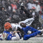 
              Buffalo Bills quarterback Josh Allen (17) takes a hit from Cincinnati Bengals defensive end Joseph Ossai (58) during the second quarter of an NFL division round football game, Sunday, Jan. 22, 2023, in Orchard Park, N.Y. The play was ruled an incomplete pass. (AP Photo/Adrian Kraus)
            