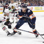 
              Chicago Blackhawks' Jake McCabe (6) tries to stop Edmonton Oilers' Connor McDavid (97) during the second period of an NHL hockey game Saturday, Jan. 28, 2023, in Edmonton, Alberta. (Jason Franson/The Canadian Press via AP)
            