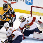
              Pittsburgh Penguins' Rickard Rakell (67) puts a rebound behind Florida Panthers goaltender Alex Lyon (34) for a goal during the first period of an NHL hockey game in Pittsburgh, Tuesday, Jan. 24, 2023. (AP Photo/Gene J. Puskar)
            