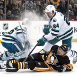 Pittsburgh Penguins' Rickard Rakell (67) is upended by San Jose Sharks' Jaycob Megna (24) during the second period of an NHL hockey game in Pittsburgh, Saturday, Jan. 28, 2023. (AP Photo/Gene J. Puskar)