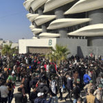 
              Iraqi football fans try to enter the Basra International Stadium in Basra, Iraq, Thursday, Jan 19, 2023. A stampede outside the stadium has killed and injured a number of people. (AP Photo/Anmar Khalil)
            