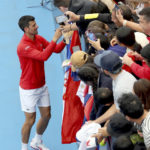 
              Serbia's Novak Djokovic signs autographs after defeating France's Quentin Halys during their Round of 16 match at the Adelaide International Tennis tournament in Adelaide, Australia, Thursday, Jan. 5, 2023. (AP Photo/Kelly Barnes)
            