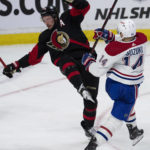 
              Montreal Canadiens center Nick Suzuki, right, collides with Ottawa Senators defenseman Thomas Chabot, left, in front of the net during second-period NHL hockey game action Saturday, Jan. 28, 2023, in Ottawa, Ontario. (Adrian Wyld/The Canadian Press via AP)
            
