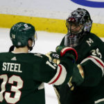 Minnesota Wild goaltender Marc-Andre Fleury (29) is congratulated by teammate Sam Steel (13) after defeating the Arizona Coyotes in an NHL hockey game Saturday, Jan. 14, 2023, in St. Paul, Minn. (AP Photo/Andy Clayton-King)