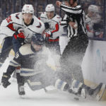 Washington Capitals' Lars Eller, left, pushes Columbus Blue Jackets' Liam Foudy to the ice during the first period of an NHL hockey game on Thursday, Jan. 5, 2023, in Columbus, Ohio. (AP Photo/Jay LaPrete)