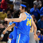 UCLA's Jamie Jaquez Jr. (24) chest-bumps Tyger Campbell after Jaquez hit a 3-pointer against Arizona State late in the second half of an NCAA college basketball game Thursday, Jan. 19, 2023, in Tempe, Ariz. UCLA won 74-62. (AP Photo/Darryl Webb)