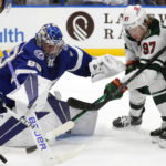 
              Tampa Bay Lightning goaltender Andrei Vasilevskiy (88) makes a save on a shot by Minnesota Wild left wing Kirill Kaprizov (97) during the third period of an NHL hockey game Tuesday, Jan. 24, 2023, in Tampa, Fla. (AP Photo/Chris O'Meara)
            