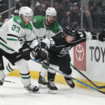 Los Angeles Kings center Blake Lizotte (46) defends against Dallas Stars defenseman Esa Lindell (23) and defenseman Jani Hakanpää (2) after losing his stick during the second period of an NHL hockey game Thursday, Jan. 19, 2023, in Los Angeles. (AP Photo/Ashley Landis)
