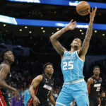 
              Charlotte Hornets forward P.J. Washington (25) pulls down an offensive rebound against the Miami Heat during the first half of an NBA basketball game in Charlotte, N.C., Sunday, Jan. 29, 2023. (AP Photo/Nell Redmond)
            