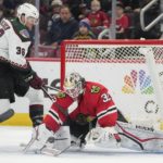 Chicago Blackhawks goaltender Alex Stalock (32) blocks a shot by Arizona Coyotes right wing Christian Fischer (36) during the third period of an NHL hockey game Friday, Jan. 6, 2023, in Chicago. (AP Photo/Erin Hooley)