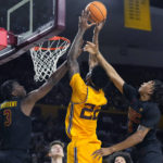 Southern California forward VIncent Iwuchukwu (3) and guard Boogie Ellis (5) defend against a shot by Arizona State forward Warren Washington (22) during the second half of an NCAA college basketball game in Tempe, Ariz., Saturday, Jan. 21, 2023. (AP Photo/Ross D. Franklin)