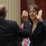 
              FILE - Sen. Nancy Skinner, D-Berkeley and state Sen. Steven Glazer, D-Orinda slap palms in celebration after her measure to let athletes at California colleges hire agents and sign endorsement deals was approved by the Senate in Sacramento, Calif., Sept. 11, 2019. A California lawmaker introduced a bill Thursday, Jan. 19, 2023, that would require schools that play major college sports to pay some athletes as much as $25,000 annually, along with covering the cost of six-year guaranteed athletic scholarships and post-college medical expenses. (AP Photo/Rich Pedroncelli, File)
            