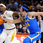 UCLA's Jamie Jaquez Jr. (24) reaches for the ball as Arizona State's Devan Cambridge drives during the second half of an NCAA college basketball game Thursday, Jan. 19, 2023, in Tempe, Ariz. UCLA won 74-62. (AP Photo/Darryl Webb)