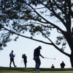 
              Jon Rahm, of Spain, center, reacts after missing a putt for birdie on the 16th hole of the South Course at Torrey Pines during the third round of the Farmers Insurance Open golf tournament, Friday, Jan. 27, 2023, in San Diego. (AP Photo/Gregory Bull)
            