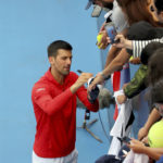 
              Serbia's Novak Djokovic signs autographs after defeating France's Quentin Halys during their Round of 16 match at the Adelaide International Tennis tournament in Adelaide, Australia, Thursday, Jan. 5, 2023. (AP Photo/Kelly Barnes)
            