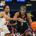 
              Connecticut's Aaliyah Edwards (3) drives past St. John's Danielle Patterson (3) during the second half of an NCAA basetball game Wednesday, Jan. 11, 2023, in New York. Connecticut won 82-52. (AP Photo/Frank Franklin II)
            
