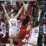 
              Ohio State's Cotie McMahon (32) shoots against Indiana's Mackenzie Holmes (54) and Yarden Garzon (12) during the second half of an NCAA college basketball game, Thursday, Jan. 26, 2023, in Bloomington, Ind. (AP Photo/Darron Cummings)
            