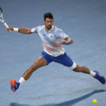 
              Novak Djokovic of Serbia plays a forehand return to Andrey Rublev of Russia during their quarterfinal match at the Australian Open tennis championship in Melbourne, Australia, Wednesday, Jan. 25, 2023. (AP Photo/Ng Han Guan)
            