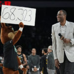
              Former San Antonio Spurs player David Robinson, right, with help from the Spurs' mascot, announces the attendance at an NBA basketball game between the Spurs and the Golden State Warriors in San Antonio, Friday, Jan. 13, 2023. The announced attendance of 68,323 sets a new NBA regular-season game attendance record. (AP Photo/Eric Gay) an NBA regular-season
            