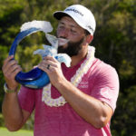 Jon Rahm, of Spain, kisses the champions trophy after the final round of the Tournament of Champions golf event, Sunday, Jan. 8, 2023, at Kapalua Plantation Course in Kapalua, Hawaii. (AP Photo/Matt York)