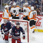 
              Philadelphia Flyers' Owen Tippett (74), Joel Farabee (86), Noah Cates (49) and Morgan Frost (48) celebrate Cates' goal against the Winnipeg Jets during the first period of an NHL hockey game, Saturday, Jan. 28, 2023 in Winnipeg, Manitoba. (John Woods/The Canadian Press via AP)
            