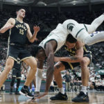 
              Michigan State center Mady Sissoko (22) falls over Purdue forward Mason Gillis (0) during the second half of an NCAA college basketball game, Monday, Jan. 16, 2023, in East Lansing, Mich. (AP Photo/Carlos Osorio)
            