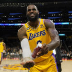 Los Angeles Lakers forward LeBron James (6) puts powdered chalk on his hands before an NBA basketball game against the Sacramento Kings in Los Angeles, Wednesday, Jan. 18, 2023. (AP Photo/Ashley Landis)