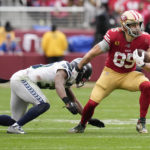 San Francisco 49ers tight end George Kittle (85) runs against Seattle Seahawks cornerback Mike Jackson during the second half of an NFL wild card playoff football game in Santa Clara, Calif., Saturday, Jan. 14, 2023. (AP Photo/Godofredo A. Vásquez)