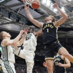 Purdue forward Caleb Furst (1) dunks as Michigan State center Mady Sissoko (22) defends during the first half of an NCAA college basketball game, Monday, Jan. 16, 2023, in East Lansing, Mich. (AP Photo/Carlos Osorio)