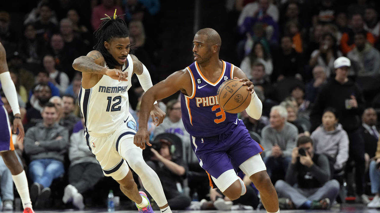 Phoenix Suns guard Chris Paul (3) runs away from Memphis Grizzlies guard Ja Morant (12) during the ...