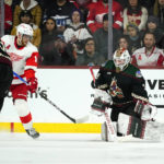 Arizona Coyotes goaltender Connor Ingram, right, makes a save on a deflection by Detroit Red Wings center Andrew Copp (18) as Coyotes' Josh Brown, left, defends during the third period of an NHL hockey game in Tempe, Ariz., Tuesday, Jan. 17, 2023. The Coyotes won 4-3 in a shootout. (AP Photo/Ross D. Franklin)