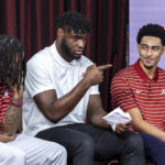 
              Alabama NCAA college football juniors Jahmyr Gibbs, from left, Will Anderson Jr. and Bryce Young chat as they wait to speak at the podium before they declared for the NFL draft, Monday, Jan. 2, 2023, in Tuscaloosa, Ala. (AP Photo/Vasha Hunt)
            