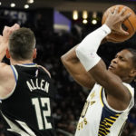 Indiana Pacers' Bennedict Mathurin, right, drives to the basket against Milwaukee Bucks' Grayson Allen during the first half of an NBA basketball game, Monday, Jan. 16, 2023, in Milwaukee. (AP Photo/Aaron Gash)