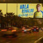 
              Vehicles pass under a billboard showing Cristiano Ronaldo with Arabic reading, "Welcome Ronaldo", in Riyadh, Saudi Arabia, late Monday, Jan 2, 2023. Ronaldo completed a lucrative move to Saudi Arabian club Al Nassr on Friday in a deal that is a landmark moment for Middle Eastern soccer but will see one of Europe's biggest stars disappear from the sport's elite stage. (AP Photo/Amr Nabil)
            