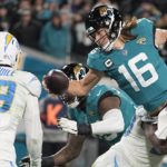
              Jacksonville Jaguars quarterback Trevor Lawrence (16) leaps for a two-point conversion against the Los Angeles Chargers during the second half of an NFL wild-card football game, Saturday, Jan. 14, 2023, in Jacksonville, Fla. (AP Photo/Chris Carlson)
            