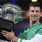 
              FILE  -Serbia's Novak Djokovic holds the Norman Brookes Challenge Cup after defeating Russia's Daniil Medvedev in the men's singles final at the Australian Open tennis championship in Melbourne, Australia, Sunday, Feb. 21, 2021.(AP Photo/Andy Brownbill, File)
            