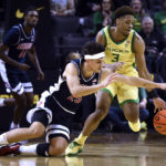 Arizona guard Kerr Kriisa (25) fouls Oregon guard Keeshawn Barthelemy (3) as he tries to steal the ball during the first half of an NCAA college basketball game Saturday, Jan. 14, 2023, in Eugene, Ore. (AP Photo/Andy Nelson)