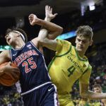 Oregon guard Brennan Rigsby (4) fouls Arizona guard Kerr Kriisa (25) during the first half of an NCAA college basketball game Saturday, Jan. 14, 2023, in Eugene, Ore. (AP Photo/Andy Nelson)