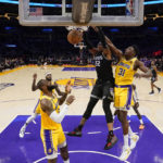 
              Sacramento Kings center Richaun Holmes (22) dunks against Los Angeles Lakers center Thomas Bryant (31) during the first half of an NBA basketball game in Los Angeles, Wednesday, Jan. 18, 2023. (AP Photo/Ashley Landis)
            