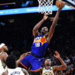 Phoenix Suns' Bismack Miyombo shoots from between three Indiana Pacers during the second half of an NBA basketball game in Phoenix, Saturday, Jan. 21, 2023. (AP Photo/Darryl Webb)