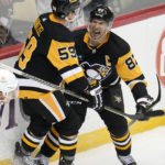
              Pittsburgh Penguins' Jake Guentzel (59) celebrates his winning goal with Sidney Crosby in overtime against the Anaheim Ducks in an NHL hockey game in Pittsburgh, Monday, Jan. 16, 2023. (AP Photo/Gene J. Puskar)
            