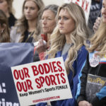 
              Former University of Kentucky swimmer Riley Gaines, second from right, stands during a rally on Thursday, Jan. 12, 2023, outside of the NCAA Convention in San Antonio. (AP Photo/Darren Abate)
            